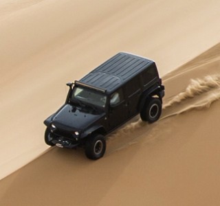 Liwa Desert Safari Tours black 4*4 vehicle dune bashing