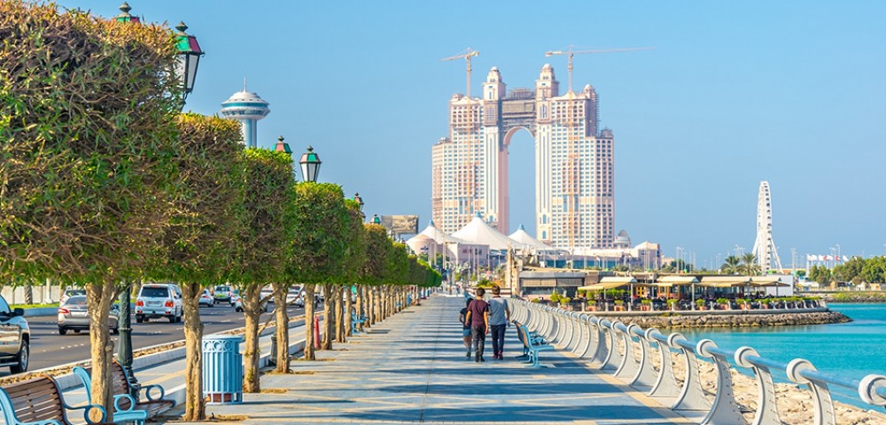 Abu Dhabi City Tour Combo beautiful skyline next to beach and group of people walking to Louvre Museum Abu Dhabi 