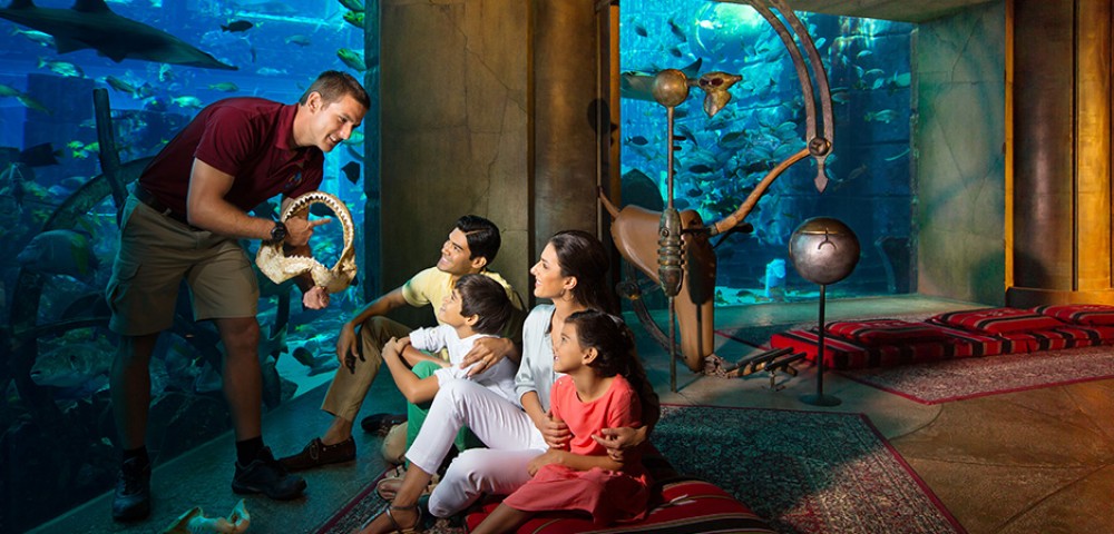 Theme Parks, Water Parks Combo Deals a girl at Aquaventure and a woman at Lost Chambers Aquarium