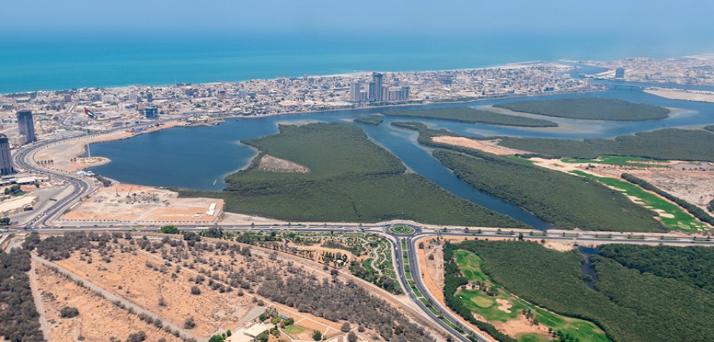 Ras Al Khaimah City Tour Combo Deals night view of tall buildings and mountains