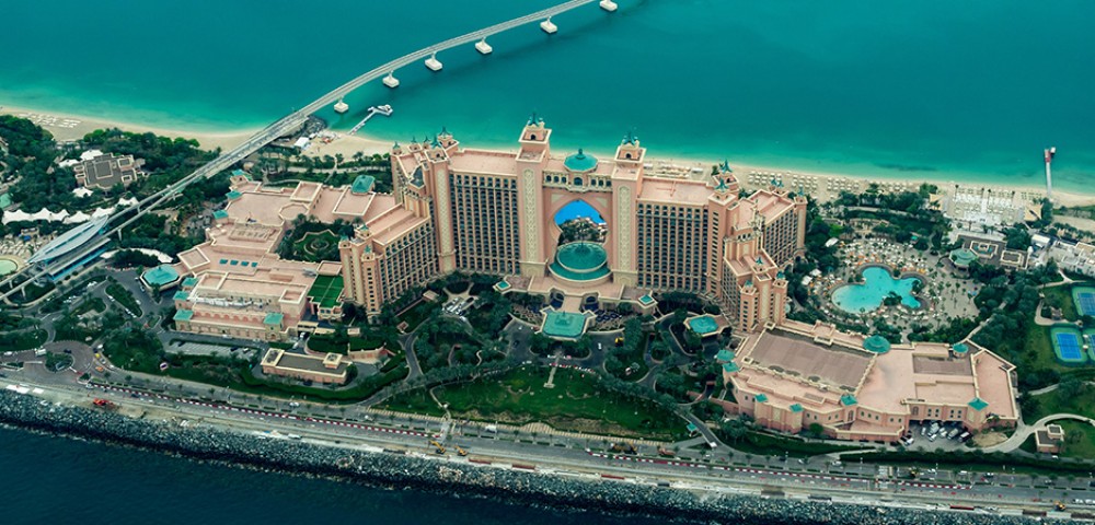 Luxury Tours Atlantis in the background of sky and palm trees