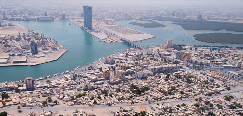 Ras Al Khaimah City Tour Combo Deals night view of tall buildings and mountains