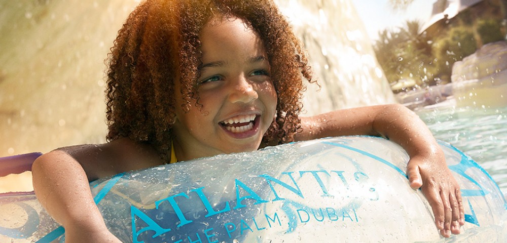 Theme Parks, Water Parks Combo Deals a girl at Aquaventure and a woman at Lost Chambers Aquarium