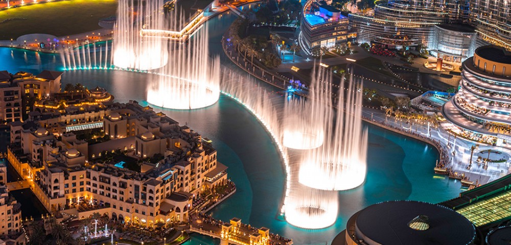 Dubai Sightseeing City Tour Combo well lit fountain and Burj Khalifa at night