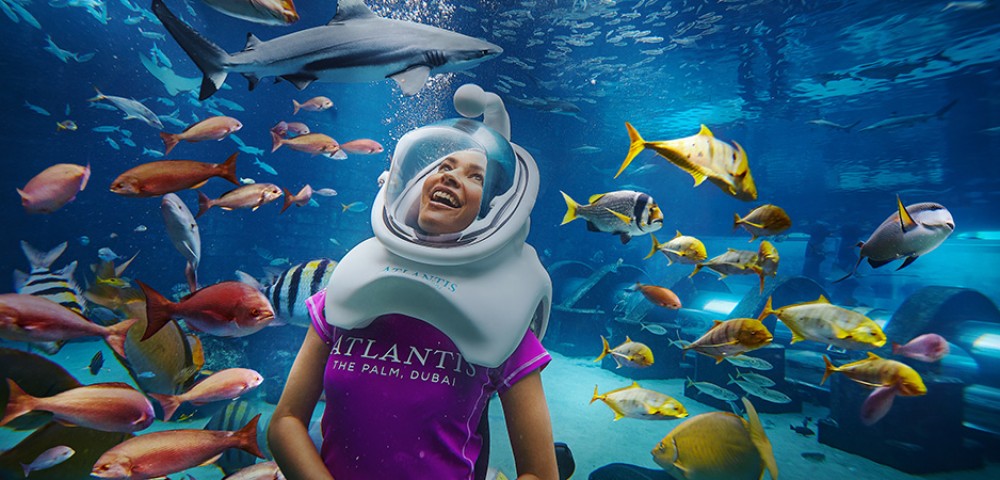 Theme Parks, Water Parks Combo Deals a girl at Aquaventure and a woman at Lost Chambers Aquarium