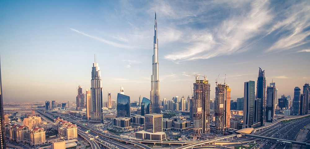 Dubai Sightseeing City Tour, a woman pointing to Burj Khalifa and Cruise Combo Deals Creek at night