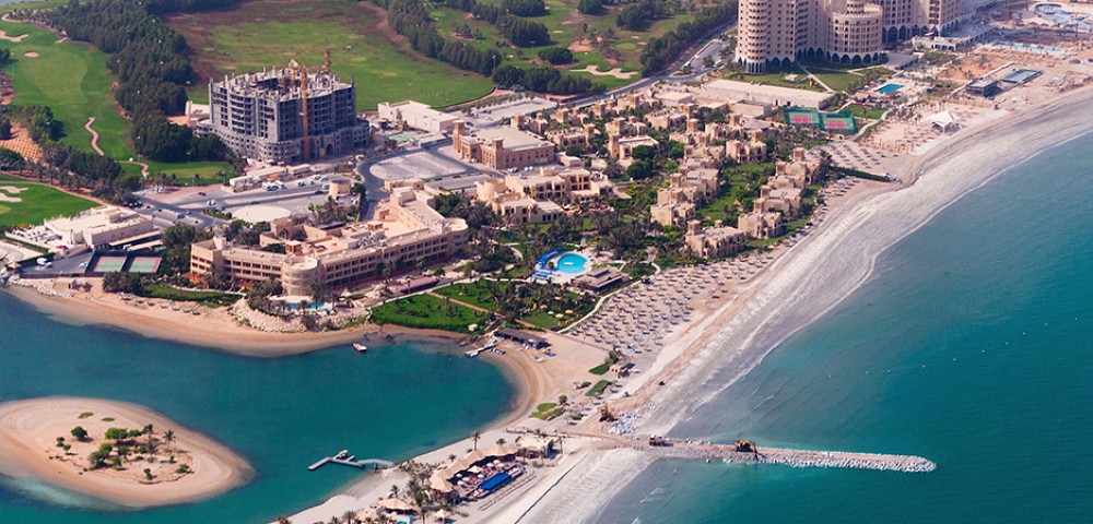 Ras Al Khaimah City Tour Combo Deals night view of tall buildings and mountains