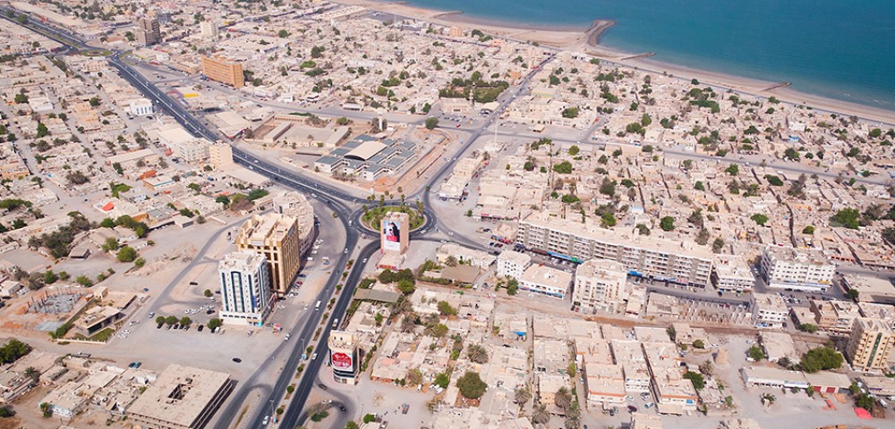 Ras Al Khaimah City Tour Combo Deals night view of tall buildings and mountains