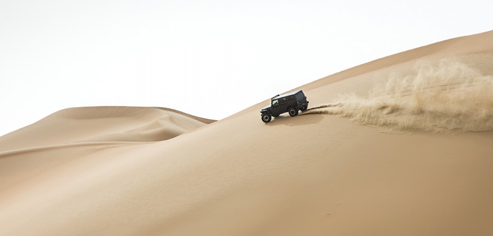 Ras Al Khaimah City Tour Combo Deals night view of tall buildings and mountains