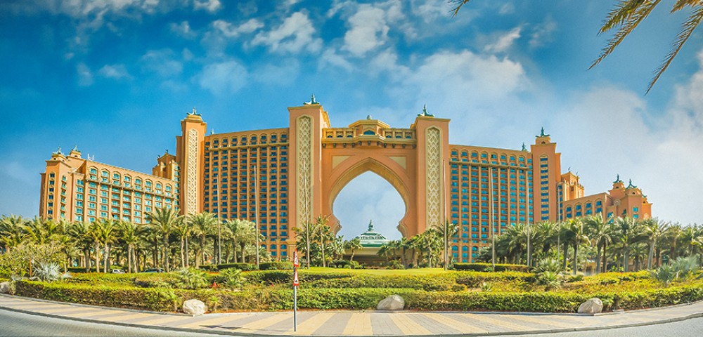 Luxury Tours Atlantis in the background of sky and palm trees