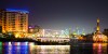 Dubai Sightseeing City Tour, a woman pointing to Burj Khalifa and Cruise Combo Deals Creek at night