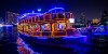 Dubai Sightseeing City Tour, a woman pointing to Burj Khalifa and Cruise Combo Deals Creek at night