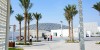 Abu Dhabi City Tour Combo beautiful skyline next to beach and group of people walking to Louvre Museum Abu Dhabi 