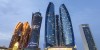 “A desert safari combo with a vehicle driving on the desert and Abu Dhabi City Tour combo  with tall buildings in the background”