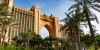 Luxury Tours Atlantis in the background of sky and palm trees