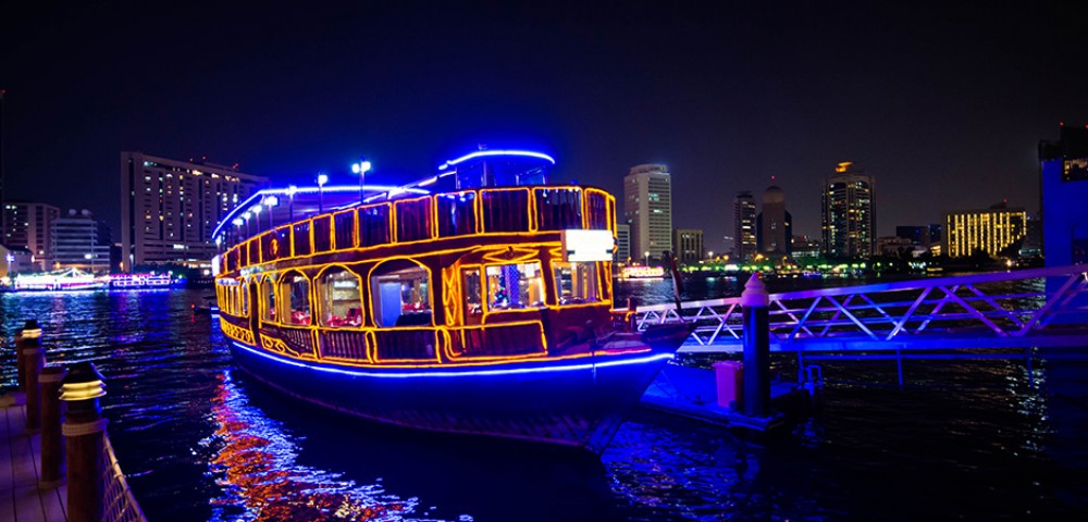 Dubai Sightseeing City Tour Combo, white 4*4 vehicle in the dunes Desert Safari and Dhow Cruise Combo dhow in the night