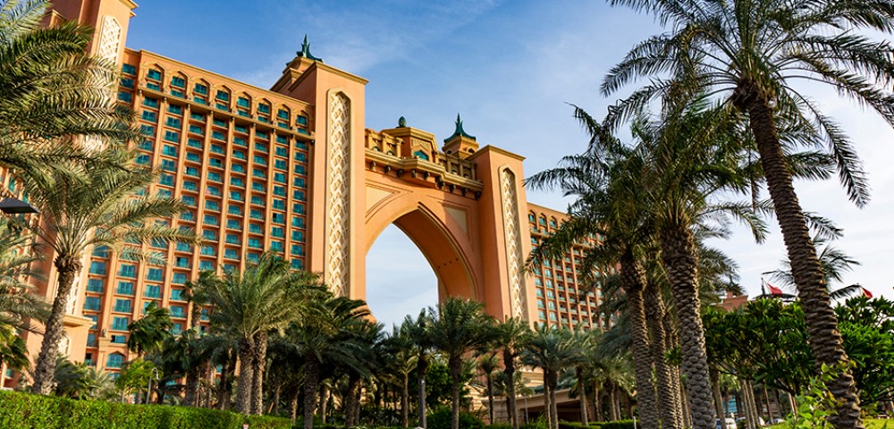 Luxury Tours Atlantis in the background of sky and palm trees