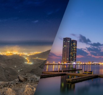 Ras Al Khaimah City Tour Combo Deals night view of tall buildings and mountains