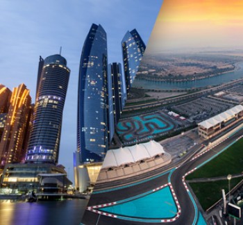 Abu Dhabi high rise buildings on the background of blue sky and Yas Water World on the background of amber sky