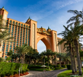 Luxury Tours Atlantis in the background of sky and palm trees