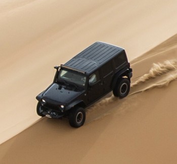 Liwa Desert Safari Tours black 4*4 vehicle dune bashing